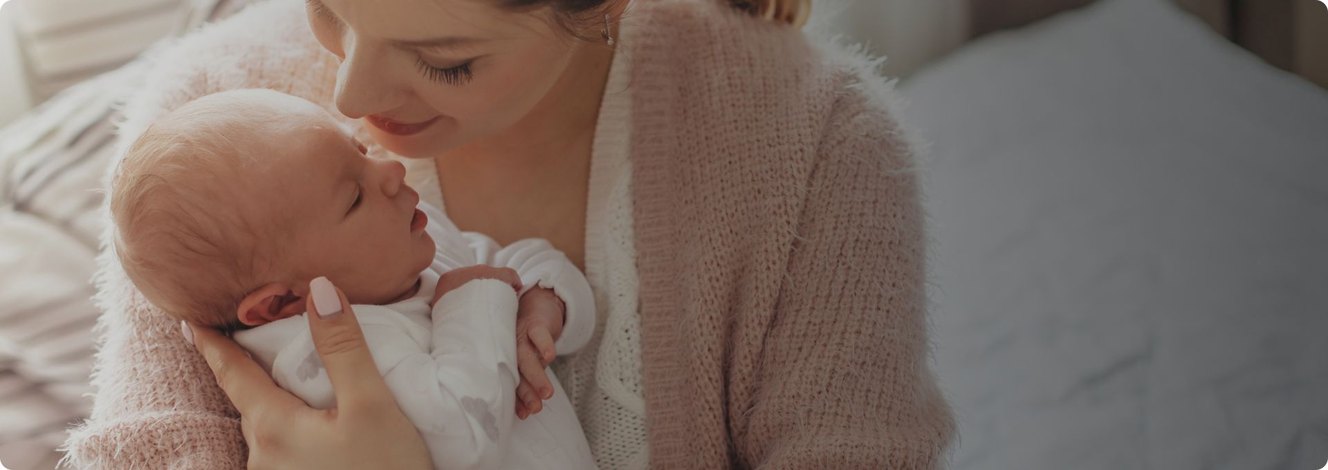 Eine Mutter die liebevoll ein Kind im Arm hat